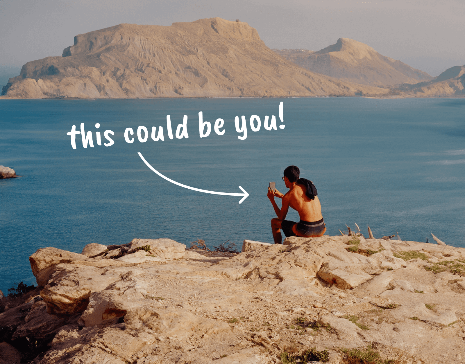 Person using phone looking out at sea